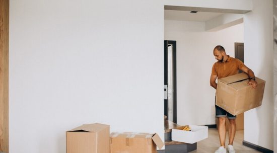 young-man-moving-into-new-house_1303-23737